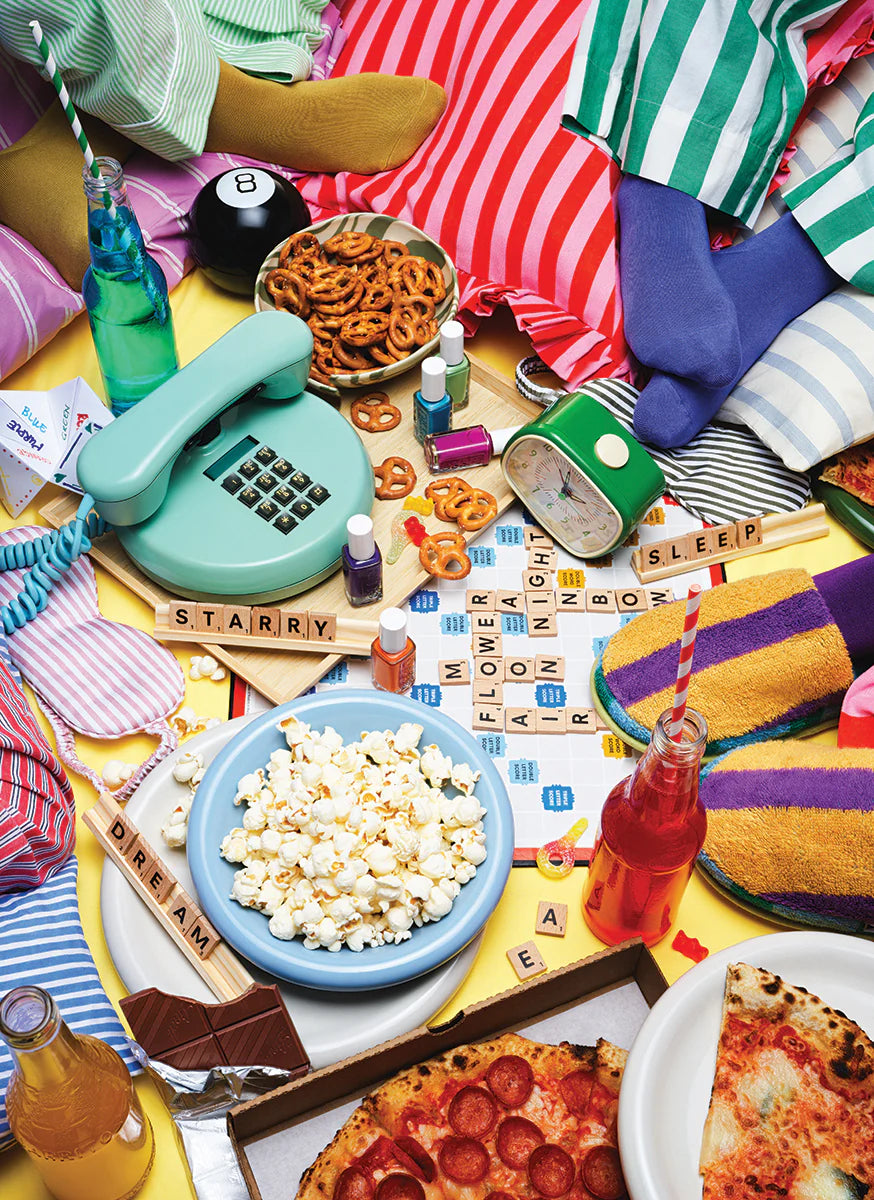 Colorful table setting with snacks, drinks, and toys on a yellow surface.